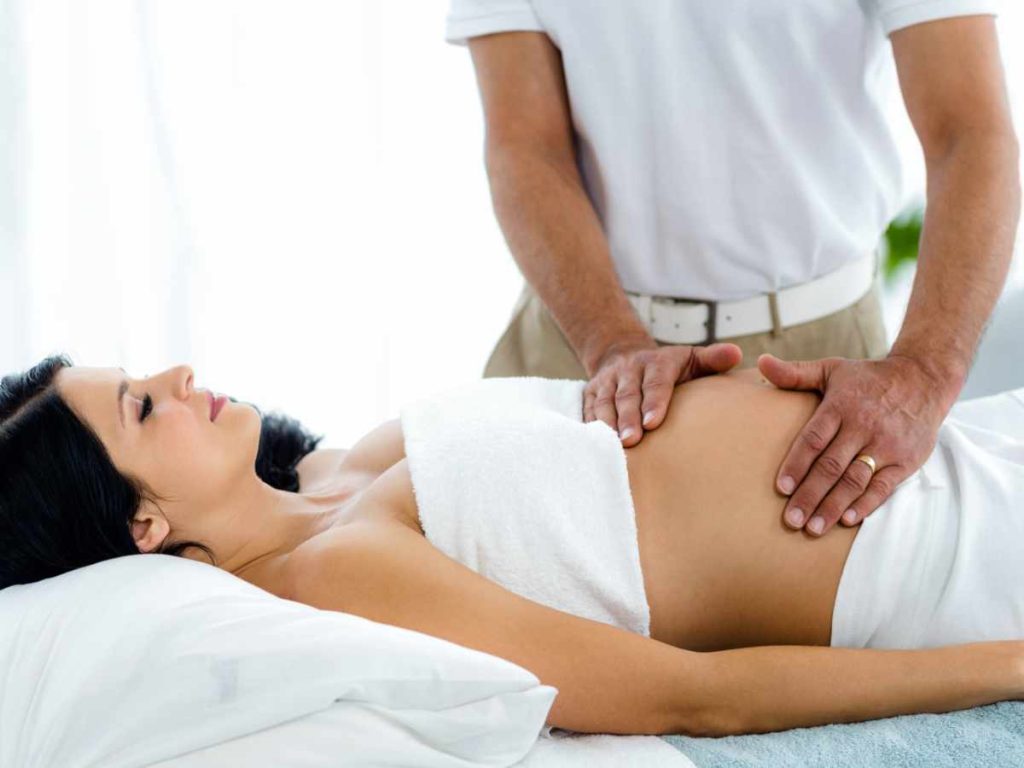 Pregnant woman receiving a pregnancy massage in colchester